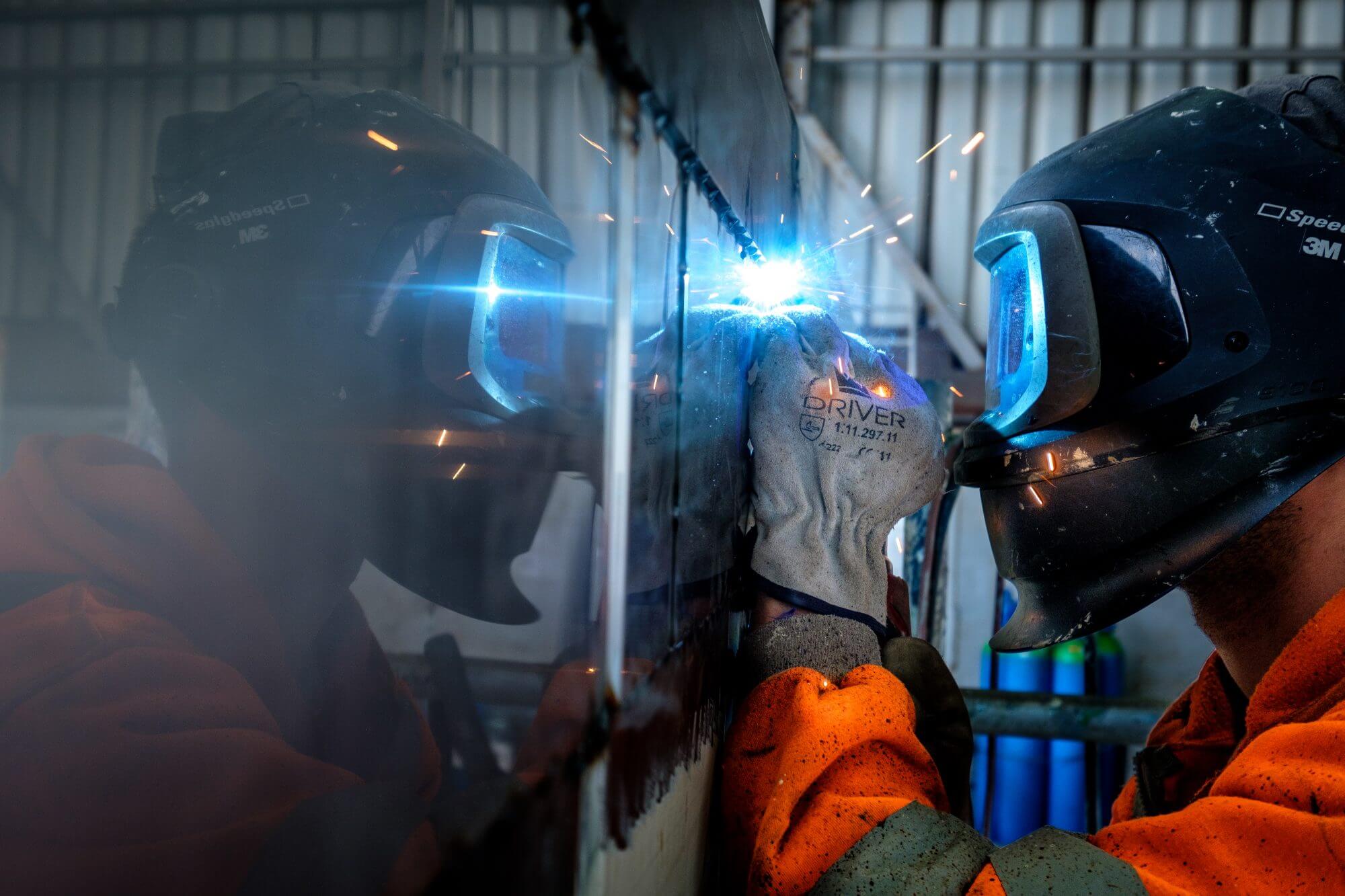 Precision Welding Services for Industrial Trailers and Containers Welder performing precision welding on an industrial trailer at Diamond Trailer Services.